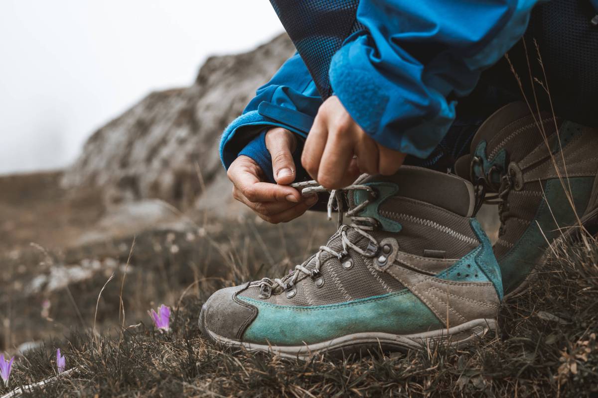 Wanderer bindet sich die Schuhe zu